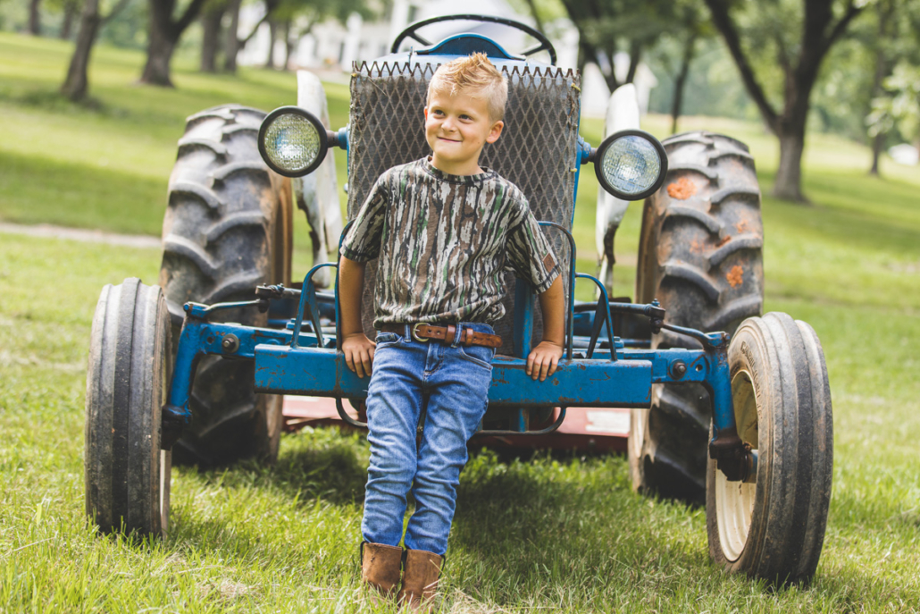 boy wearing bc raskulls camo short sleeve tee on tractor