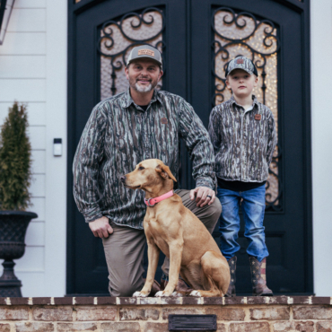 bc raskulls man-child adult twill button-up shirt michael waddell and child posing with dog